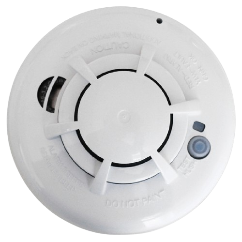 This image shows a white, circular smoke detector. It's mounted on a ceiling or wall, with vents, a central sensor, and a caution label.